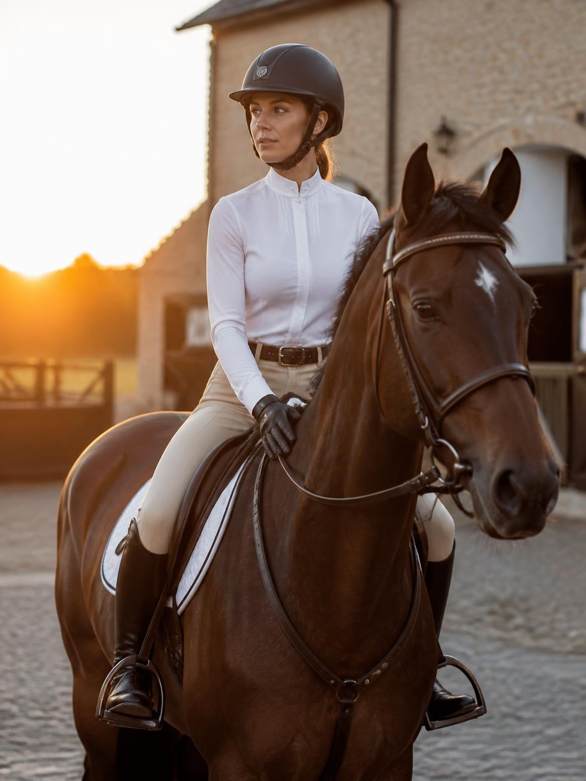 Equellen rider jumping at golden hour in a European arena